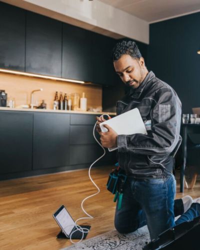 A custom cabling tech installing a home office network